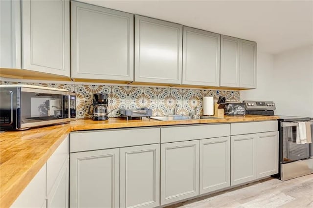 2711 Briley St, Mobile, AL 36606 - kitchen featuring stainless steel appliances, backsplash, and wood counters