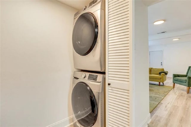 2711 Briley St, Mobile, AL 36606 - laundry area featuring stacked washer and clothes dryer and wood finished floors