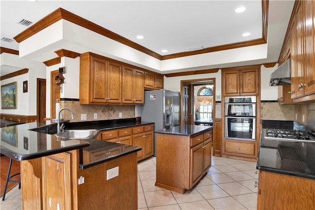 kitchen featuring a kitchen island, stainless steel appliances, sink, ventilation hood, and a kitchen bar