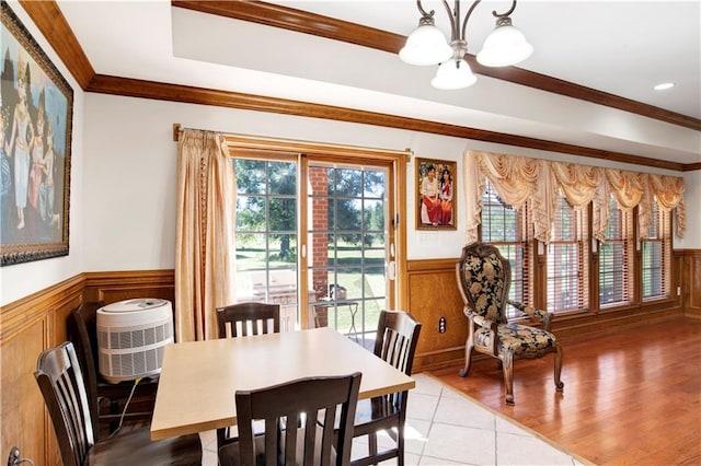 dining area with light hardwood / wood-style floors, a notable chandelier, and ornamental molding