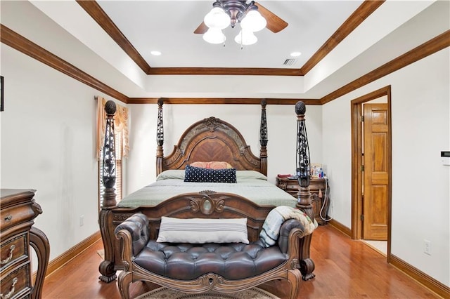 bedroom featuring ornamental molding, light wood-type flooring, and ceiling fan