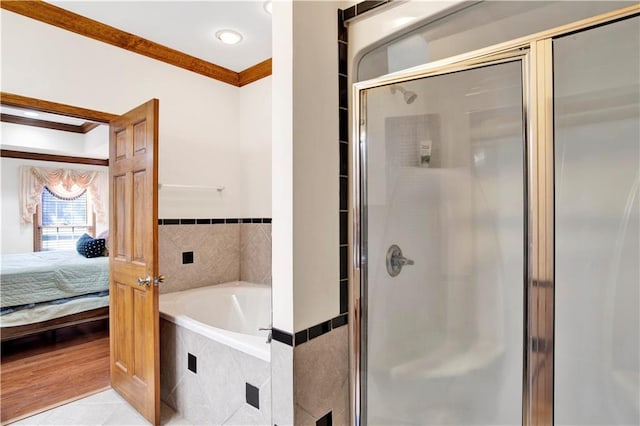 bathroom featuring ornamental molding, shower with separate bathtub, and hardwood / wood-style flooring