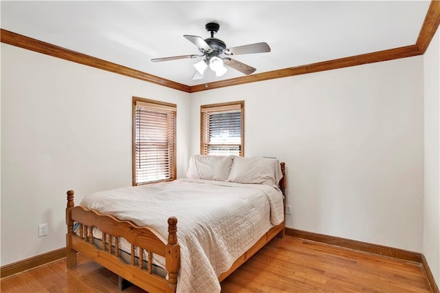 bedroom featuring ceiling fan, crown molding, and light hardwood / wood-style flooring