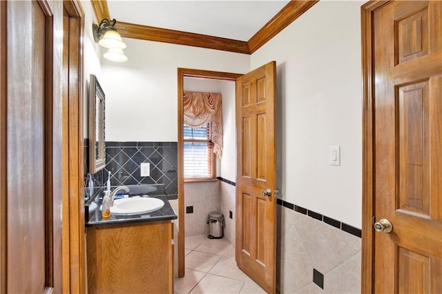 bathroom with tile walls, vanity, crown molding, and tile patterned floors