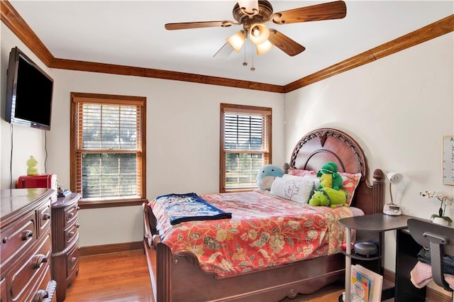 bedroom with ceiling fan, ornamental molding, multiple windows, and light wood-type flooring