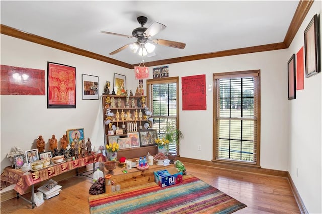 playroom with ceiling fan, crown molding, and hardwood / wood-style floors