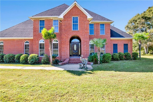 colonial inspired home with a front lawn