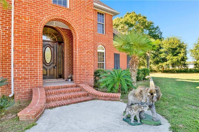 doorway to property with a yard