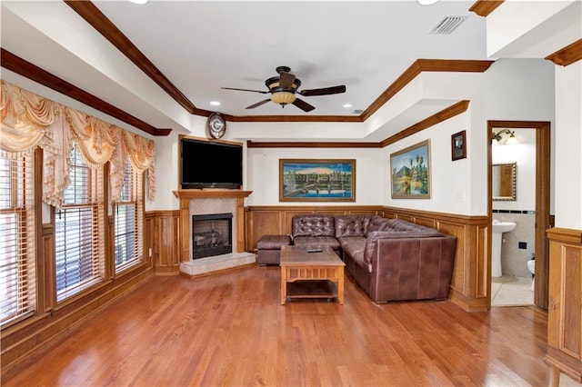 unfurnished living room featuring crown molding, light hardwood / wood-style flooring, and ceiling fan