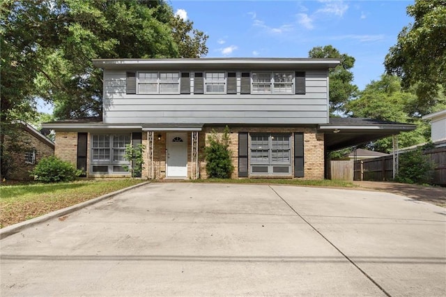 317 Syracuse St, Mobile, AL 36608 - view of front of home with brick siding, driveway, and a carport