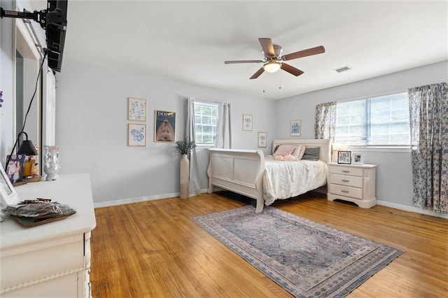 317 Syracuse St, Mobile, AL 36608 - bedroom with light wood-style flooring, baseboards, a barn door, and ceiling fan