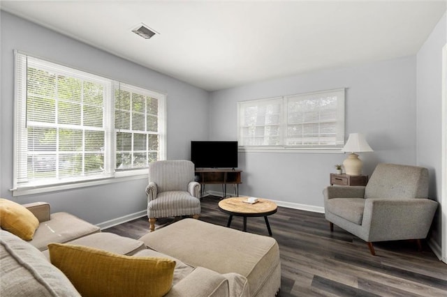 317 Syracuse St, Mobile, AL 36608 - living area featuring healthy amount of natural light, dark wood-style floors, and baseboards