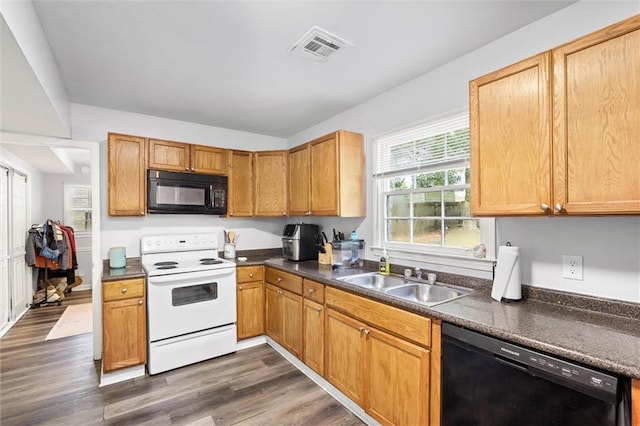 317 Syracuse St, Mobile, AL 36608 - kitchen featuring black appliances, a sink, dark countertops, and dark wood finished floors
