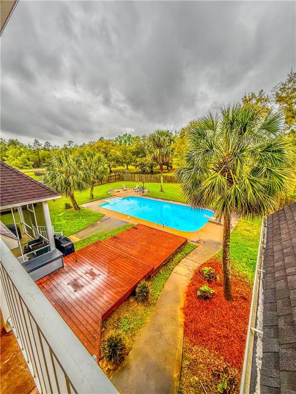 2801 Dog River Rd, Theodore, AL 36582 - outdoor pool featuring a yard and a deck
