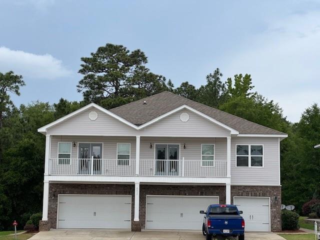 6857 Spaniel Dr Unit A, Daphne, AL 36527 - view of front facade with brick siding, a garage, and concrete driveway