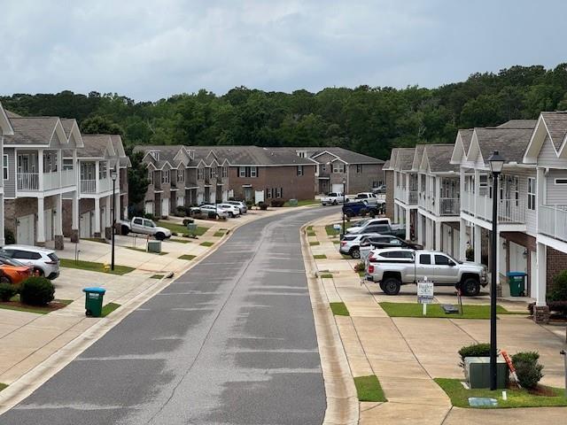 6857 Spaniel Dr Unit A, Daphne, AL 36527 - view of asphalt road with a residential view, curbs, and sidewalks