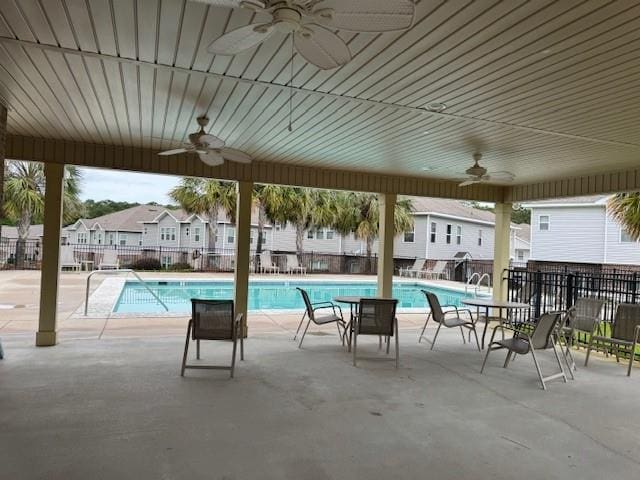 6857 Spaniel Dr Unit A, Daphne, AL 36527 - community pool with a ceiling fan, a patio, and a residential view