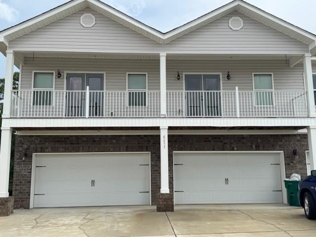 6857 Spaniel Dr Unit A, Daphne, AL 36527 - view of front of property featuring brick siding, a garage, and concrete driveway