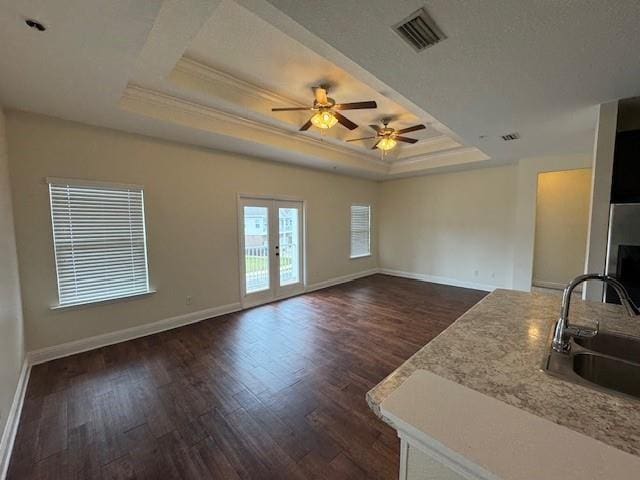 6857 Spaniel Dr Unit A, Daphne, AL 36527 - unfurnished living room with a sink, a ceiling fan, dark wood-type flooring, a tray ceiling, and baseboards
