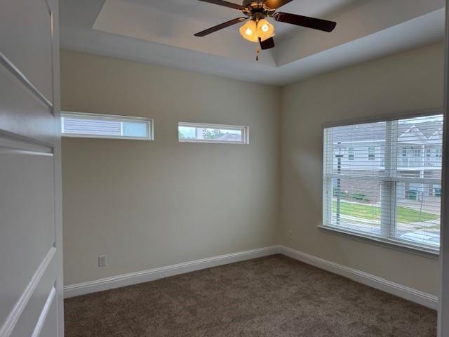 6857 Spaniel Dr Unit A, Daphne, AL 36527 - empty room with healthy amount of natural light, a tray ceiling, carpet floors, and a ceiling fan