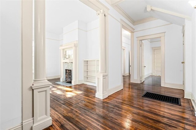 corridor featuring decorative columns and dark hardwood / wood-style flooring