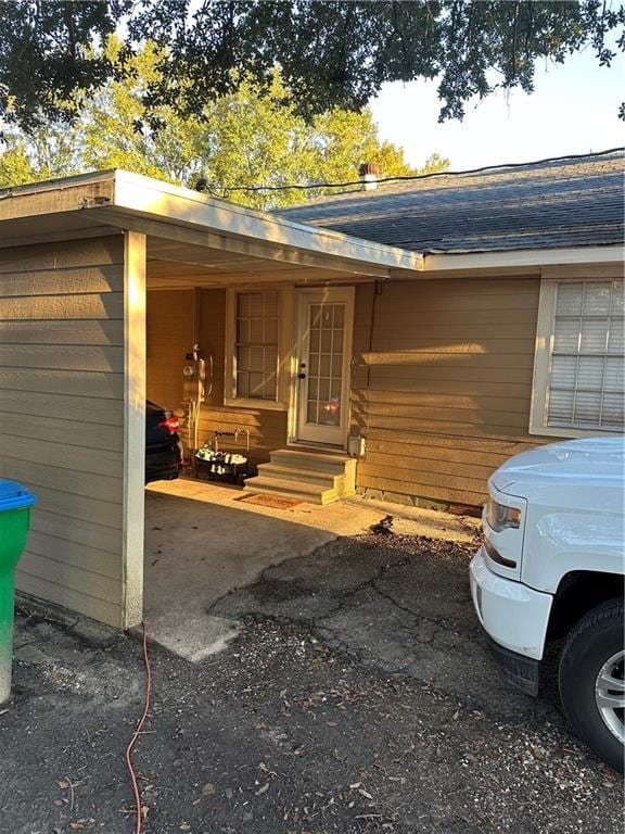 doorway to property with a carport