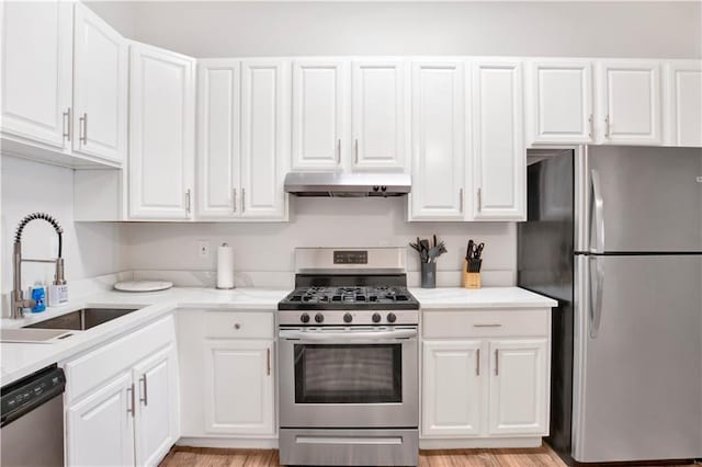 kitchen with white cabinetry, sink, light hardwood / wood-style floors, and appliances with stainless steel finishes