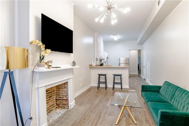 living room featuring light hardwood / wood-style flooring and a chandelier