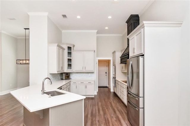 kitchen with stainless steel appliances, hanging light fixtures, sink, dark hardwood / wood-style floors, and white cabinetry