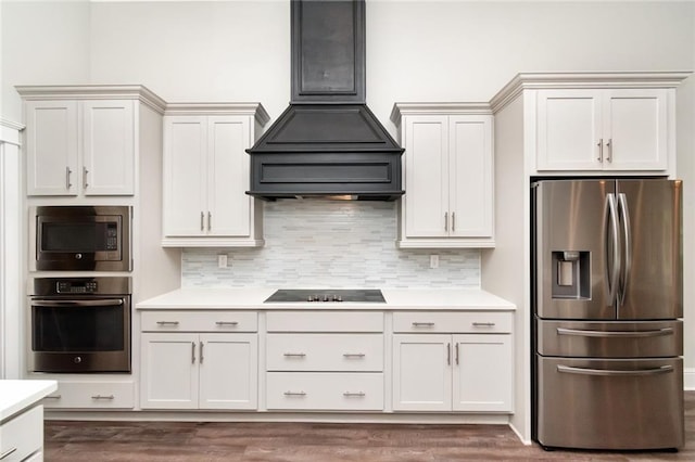 kitchen with stainless steel appliances, white cabinetry, custom exhaust hood, and dark hardwood / wood-style flooring