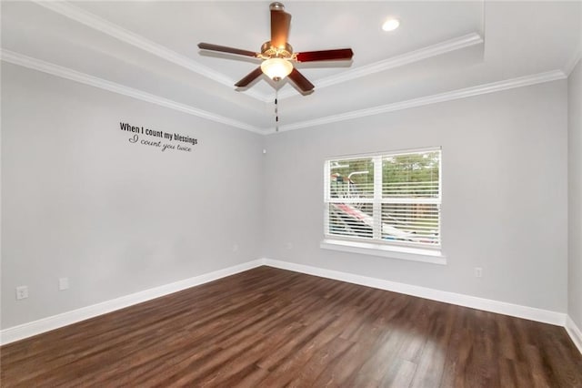 spare room featuring ceiling fan, dark hardwood / wood-style floors, a raised ceiling, and crown molding