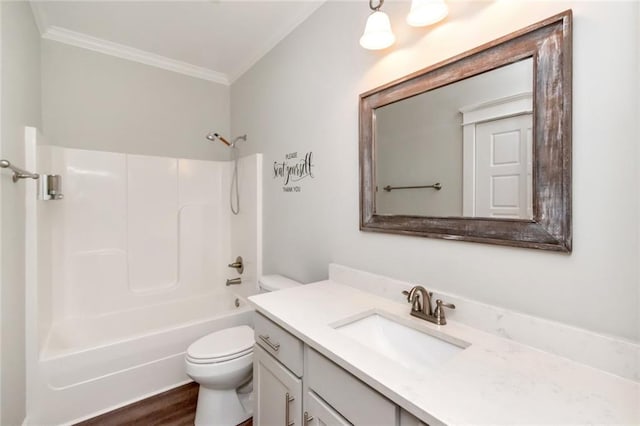 full bathroom featuring tub / shower combination, wood-type flooring, vanity, crown molding, and toilet