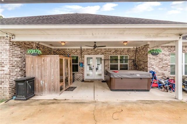 view of patio / terrace featuring ceiling fan, a hot tub, and french doors