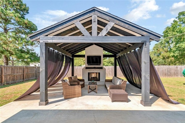 view of patio featuring exterior fireplace and a gazebo