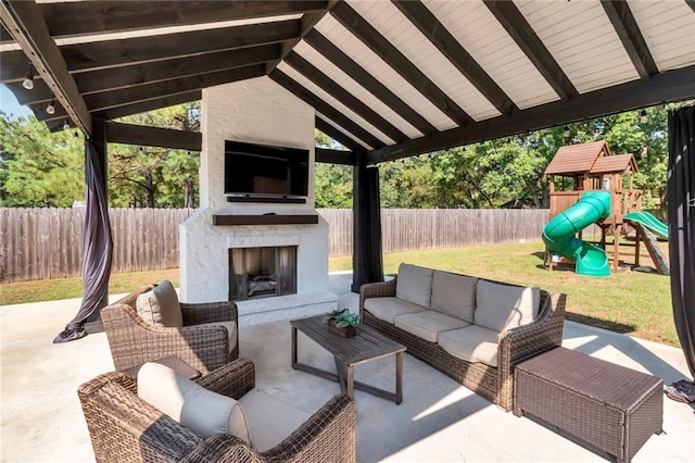 view of patio / terrace featuring a playground and an outdoor living space with a fireplace