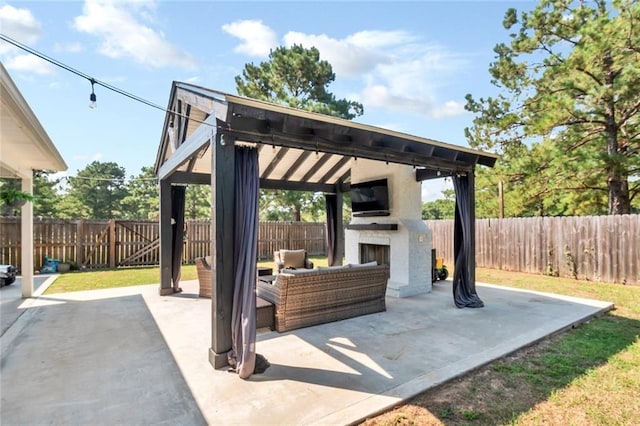 view of patio featuring an outdoor living space with a fireplace