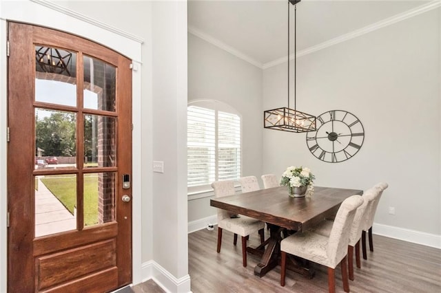 dining room featuring hardwood / wood-style floors and crown molding