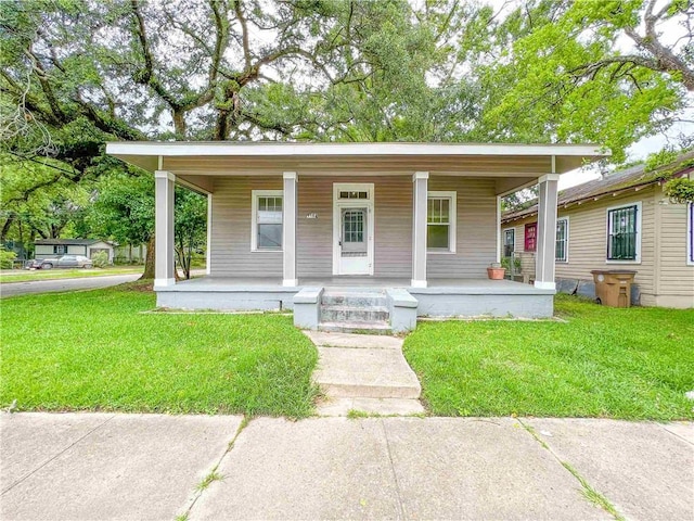 bungalow-style house with a porch and a front lawn