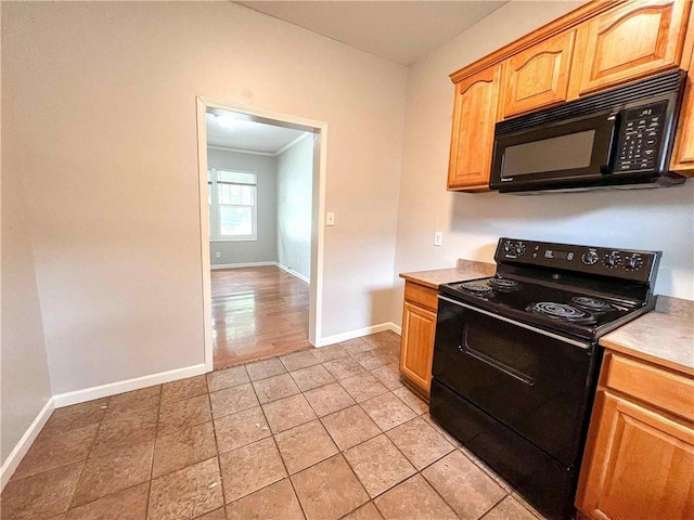 kitchen featuring black appliances, light tile patterned floors, baseboards, and light countertops