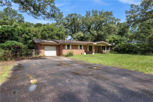 1259 Marietta Dr W, Mobile, AL 36618 - ranch-style home featuring an attached garage, driveway, brick siding, and a front lawn