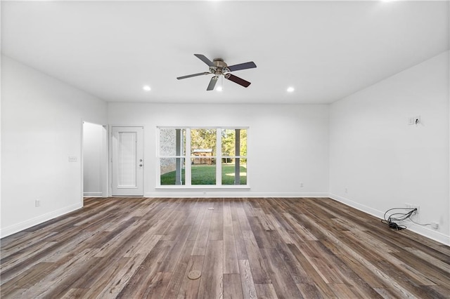 spare room featuring dark wood-type flooring and ceiling fan