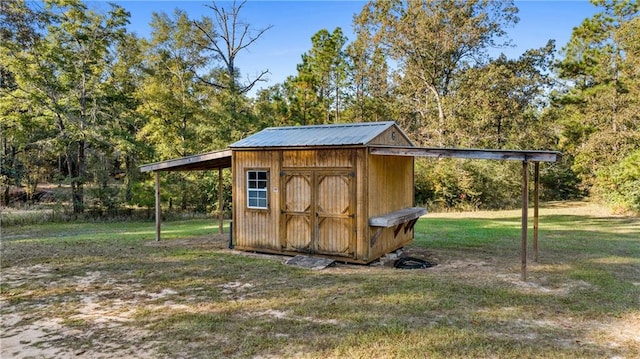 view of outbuilding featuring a yard