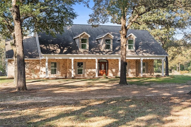 cape cod-style house featuring a porch