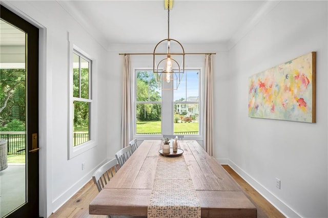 313 Cuban Lilly Dr, Fairhope, AL 36532 - dining area featuring wood finished floors, baseboards, a chandelier, and ornamental molding