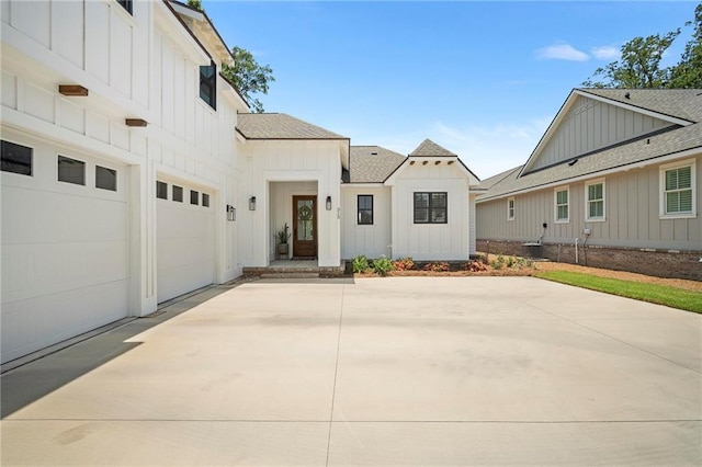 313 Cuban Lilly Dr, Fairhope, AL 36532 - modern farmhouse style home featuring board and batten siding, roof with shingles, a garage, and driveway