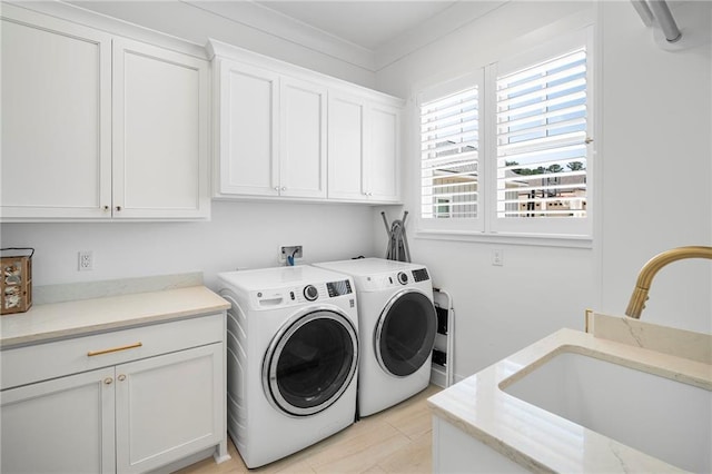 313 Cuban Lilly Dr, Fairhope, AL 36532 - laundry area with cabinet space and separate washer and dryer