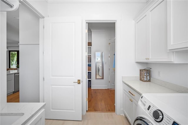 313 Cuban Lilly Dr, Fairhope, AL 36532 - laundry area with cabinet space and washing machine and clothes dryer