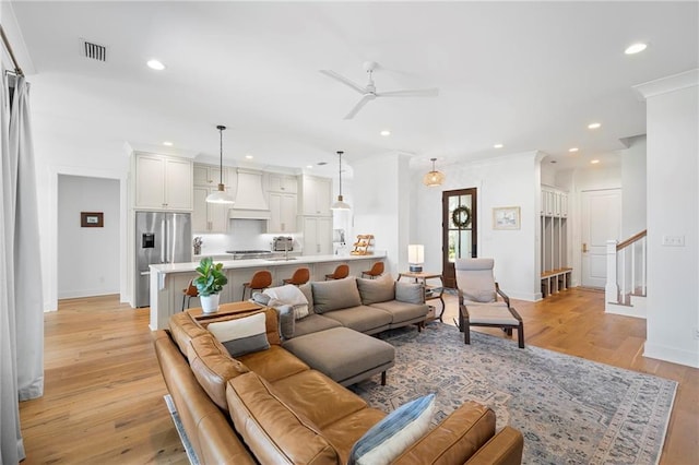 313 Cuban Lilly Dr, Fairhope, AL 36532 - living area with a ceiling fan, baseboards, recessed lighting, light wood-type flooring, and crown molding