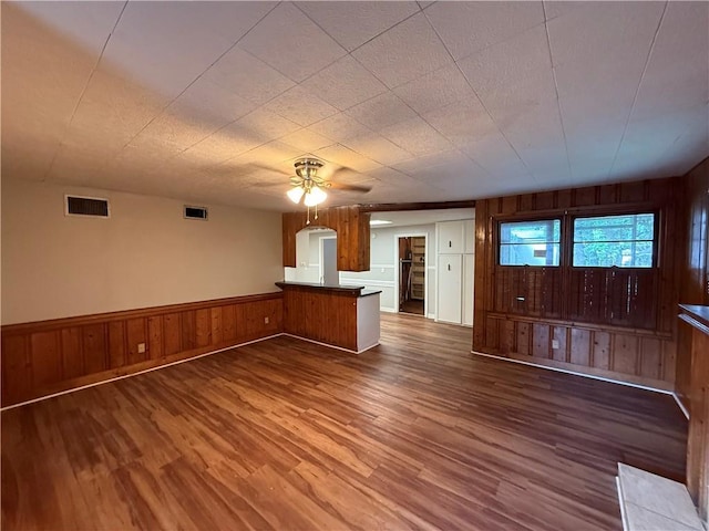 6 Elizabeth Ave, Chickasaw, AL 36611 - unfurnished living room featuring ceiling fan, wood finished floors, and wood walls