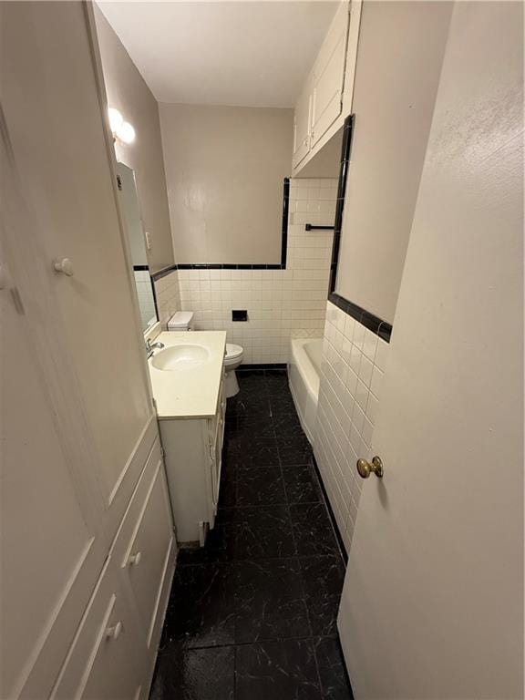 6 Elizabeth Ave, Chickasaw, AL 36611 - full bath with tile walls, vanity, a bathtub, wainscoting, and tile patterned floors